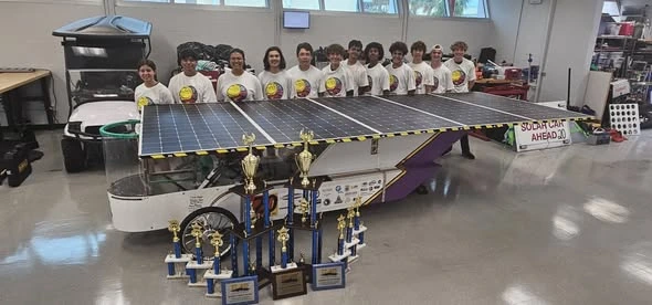2026 ALSET Paladins solar racing team with their car and championship trophies